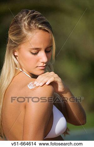 Young woman protecting herself from the sun. View Large Photo Image Picture - Young woman protecting herself from the sun.. Fotosearch