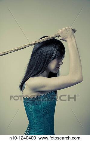 Young woman pulling on the end of a rope View Large Photo Image Stock Image - Young woman pulling on the end of a rope. Fotosearch