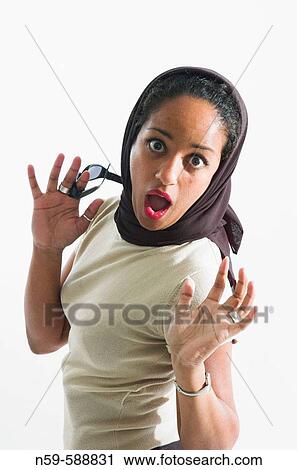 Stock Image - Young woman reacting with surprise.. Fotosearch