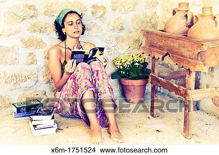 young woman reading a book View Large Photo Image Picture - young woman reading a book. Fotosearch