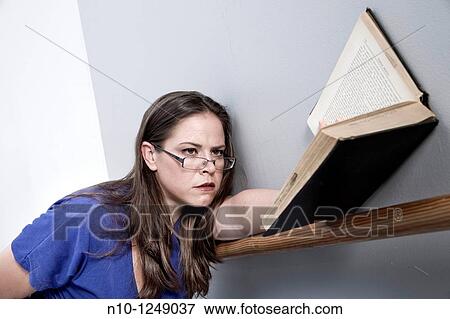 Young woman reading a book View Large Photo Image Stock Photo - Young woman reading a book. Fotosearch