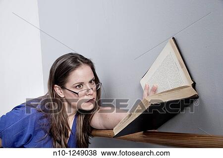 Young woman reading a book View Large Photo Image Stock Photo - Young woman reading a book. Fotosearch