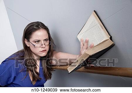 Young woman reading a book View Large Photo Image Stock Photo - Young woman reading a book. Fotosearch