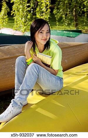 young woman reading book outdoor View Large Photo Image Stock Photo - young woman reading book outdoor. Fotosearch