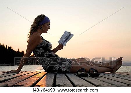 Young woman reading by Lake Como at sunset, Italy View Large Photo Image Stock Image - Young woman reading by Lake Como at sunset, Italy. Fotosearch