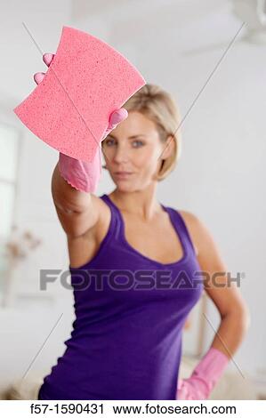 Stock Image - Young woman ready to clean the house. Fotosearch