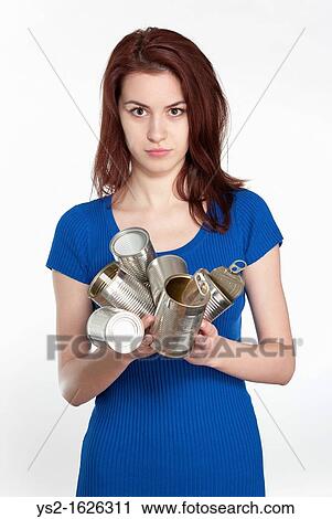 Young woman recycling tin cans View Large Photo Image Stock Image - Young woman recycling tin cans. Fotosearch