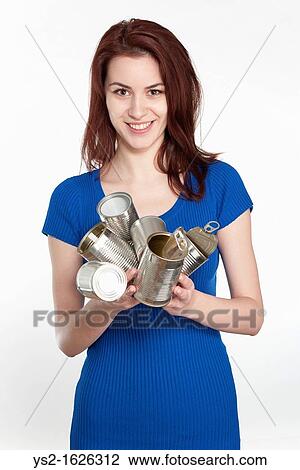 Young woman recycling tin cans View Large Photo Image Stock Image - Young woman recycling tin cans. Fotosearch