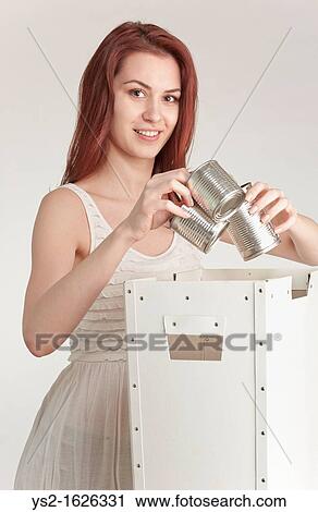 Young woman recycling tin cans View Large Photo Image Stock Image - Young woman recycling tin cans. Fotosearch