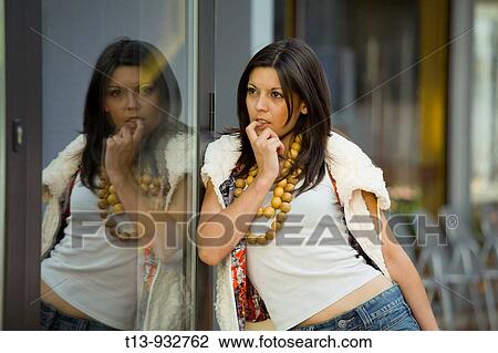 Young woman reflecting in glass wall View Large Photo Image Stock Image - Young woman reflecting in glass wall. Fotosearch