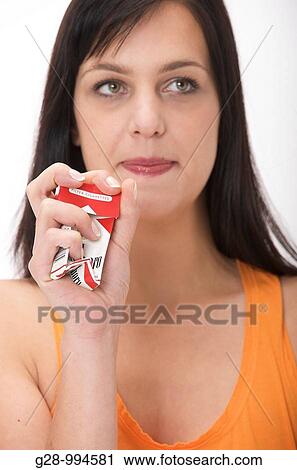 young woman refusing to smoke by crushing a packet of cigarettes View Large Photo Image Stock Image - young woman refusing to smoke by crushing a packet of cigarettes. Fotosearch