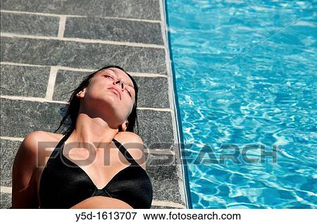 young woman relaxing at swimming pool, summertime View Large Photo Image Stock Photo - young woman relaxing at swimming pool, summertime. Fotosearch