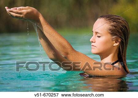 Stock Photo - Young woman relaxing in a pool. Fotosearch