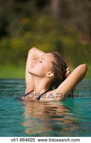Young woman relaxing in swimming-pool. View Large Photo Image Stock Image - Young woman relaxing in swimming-pool.. Fotosearch
