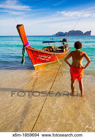 Picture - Young woman relaxing Long beach Phi Phi Don island Krabi province, Andaman Sea, Thailand. Fotosearch