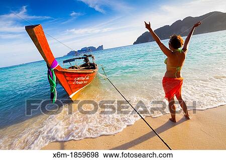 Young woman relaxing Long beach Phi Phi Don island Krabi province, Andaman Sea, Thailand View Large Photo Image Stock Photo - Young woman relaxing Long beach Phi Phi Don island Krabi province, Andaman Sea, Thailand. Fotosearch
