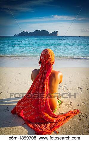 Stock Photo - Young woman relaxing Long beach Phi Phi Don island Krabi province, Andaman Sea, Thailand. Fotosearch