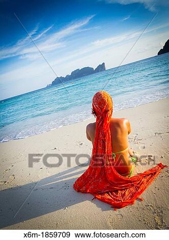 Stock Photo - Young woman relaxing Long beach Phi Phi Don island Krabi province, Andaman Sea, Thailand. Fotosearch