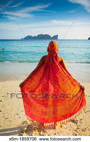 Stock Photograph - Young woman relaxing Long beach Phi Phi Don island Krabi province, Andaman Sea, Thailand. Fotosearch