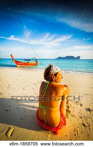 Young woman relaxing Long beach Phi Phi Don island Krabi province, Andaman Sea, Thailand View Large Photo Image Stock Photography - Young woman relaxing Long beach Phi Phi Don island Krabi province, Andaman Sea, Thailand. Fotosearch