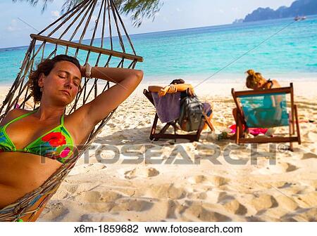 Young woman relaxing on a hammock Long beach Phi Phi Don island Krabi province, Andaman Sea, Thailand View Large Photo Image Stock Image - Young woman relaxing on a hammock Long beach Phi Phi Don island Krabi province, Andaman Sea, Thailand. Fotosearch
