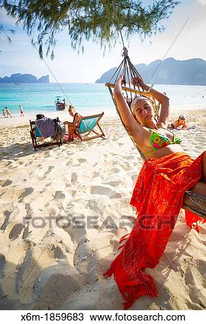 Young woman relaxing on a hammock Long beach Phi Phi Don island Krabi province, Andaman Sea, Thailand View Large Photo Image Stock Image - Young woman relaxing on a hammock Long beach Phi Phi Don island Krabi province, Andaman Sea, Thailand. Fotosearch