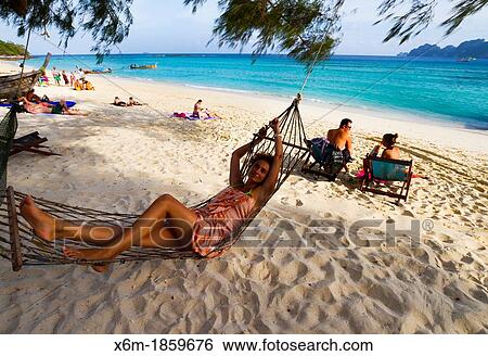 Young woman relaxing on a hammock Long beach Phi Phi Don island Krabi province, Andaman Sea, Thailand View Large Photo Image Stock Photograph - Young woman relaxing on a hammock Long beach Phi Phi Don island Krabi province, Andaman Sea, Thailand. Fotosearch