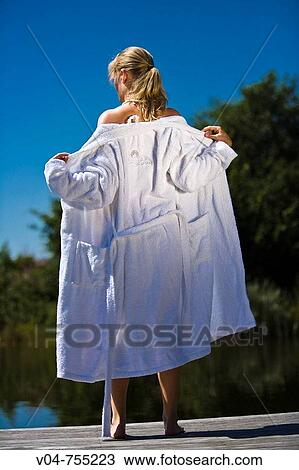 Young woman removes her bathrobe to take a swim in a lake View Large Photo Image Stock Image - Young woman removes her bathrobe to take a swim in a lake. Fotosearch