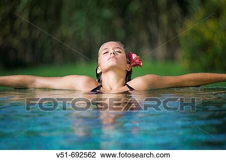 Young woman resting at the pool View Large Photo Image Stock Image - Young woman resting at the pool. Fotosearch