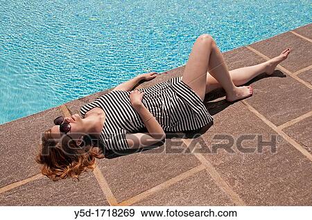 young woman resting at the swimming pool View Large Photo Image Stock Photo - young woman resting at the swimming pool. Fotosearch