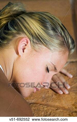 Young woman resting by a pool View Large Photo Image Stock Image - Young woman resting by a pool. Fotosearch