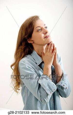 Young woman, resting her chin on her hands, thoughtful, dreaming View Large Photo Image Stock Image - Young woman, resting her chin on her hands, thoughtful, dreaming. Fotosearch