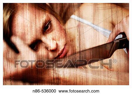 Stock Image - Young woman running a knife over her wrist. Fotosearch