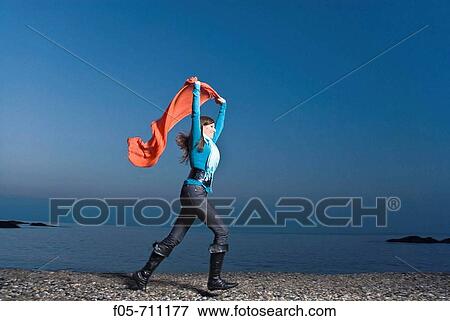 Young woman running along the seashore at dawn View Large Photo Image Stock Photo - Young woman running along the seashore at dawn. Fotosearch