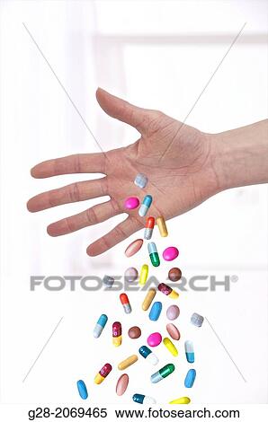 Young woman? s hands, close up, dropping a handful of colored tablets View Large Photo Image Stock Photography - Young woman? s hands, close up, dropping a handful of colored tablets. Fotosearch