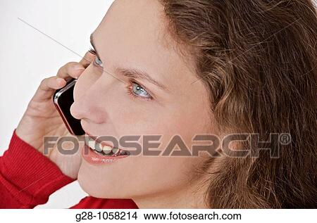 young woman? s hands holding a telephone and expressing her happiness with a smile View Large Photo Image Picture - young woman? s hands holding a telephone and expressing her happiness with a smile. Fotosearch