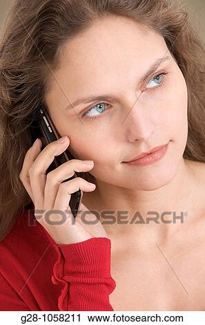 young woman? s hands holding a telephone and looking serious, and listening attentively View Large Photo Image Stock Image - young woman? s hands holding a telephone and looking serious, and listening attentively. Fotosearch