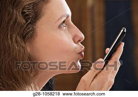 young woman? s hands holding a telephone and expressing her love or hope by kissing it View Large Photo Image Stock Photo - young woman? s hands holding a telephone and expressing her love or hope by kissing it. Fotosearch