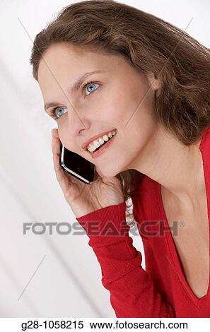 young woman? s hands holding a telephone and expressing her happiness with a smile View Large Photo Image Stock Photography - young woman? s hands holding a telephone and expressing her happiness with a smile. Fotosearch