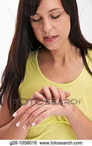 young woman scratching her hand View Large Photo Image Stock Photograph - young woman scratching her hand. Fotosearch