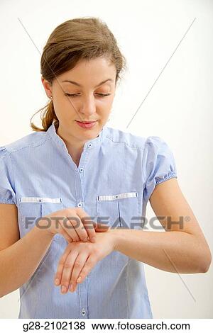 Young woman scratching her itching skin on wrist with her hand View Large Photo Image Stock Photo - Young woman scratching her itching skin on wrist with her hand. Fotosearch