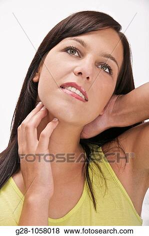 young woman scratching her neck or suffering from a pain in the neck View Large Photo Image Stock Photo - young woman scratching her neck or suffering from a pain in the neck. Fotosearch