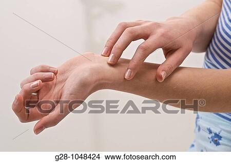 young woman scratching herself because of an itching sensation View Large Photo Image Picture - young woman scratching herself because of an itching sensation. Fotosearch
