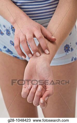 young woman scratching herself because of an itching sensation View Large Photo Image Stock Image - young woman scratching herself because of an itching sensation. Fotosearch