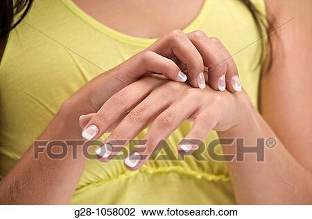 young woman scratching the top of her hand View Large Photo Image Stock Image - young woman scratching the top of her hand. Fotosearch
