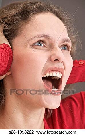 Stock Image - young woman screeming out of fear, despair, fright or stress. Fotosearch