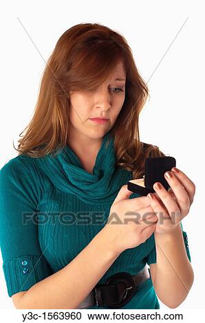 Young woman seems to be disappointed when opening a gift ring box View Large Photo Image Stock Image - Young woman seems to be disappointed when opening a gift ring box. Fotosearch