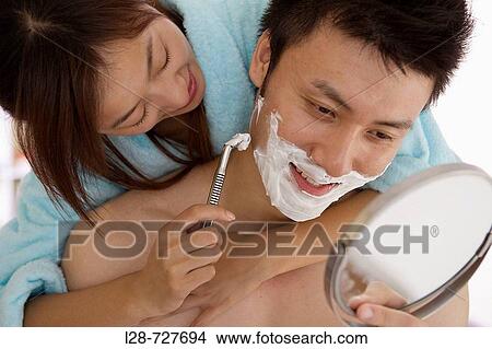Young woman shaving young man, smiling, close-up View Large Photo Image Picture - Young woman shaving young man, smiling, close-up. Fotosearch