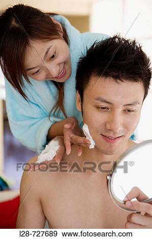 Young woman shaving young man, smiling, close-up View Large Photo Image Stock Photo - Young woman shaving young man, smiling, close-up. Fotosearch