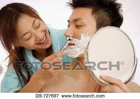 Young woman shaving young man, smiling, close-up View Large Photo Image Stock Photo - Young woman shaving young man, smiling, close-up. Fotosearch